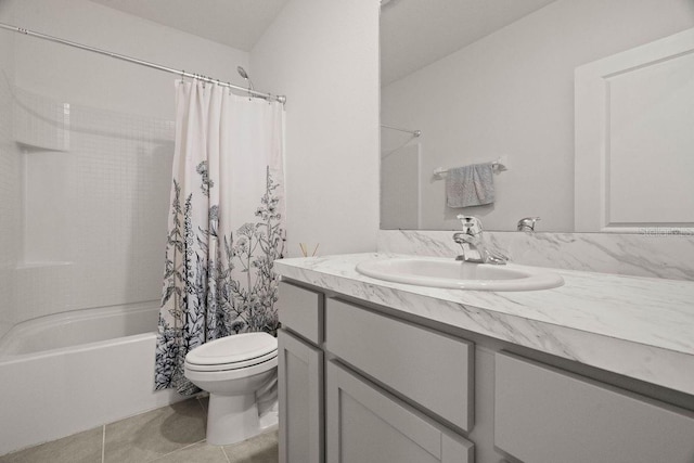 full bathroom with shower / bath combo with shower curtain, toilet, vanity, and tile patterned flooring