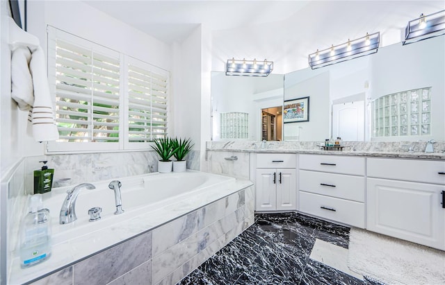 bathroom featuring vanity and a relaxing tiled tub