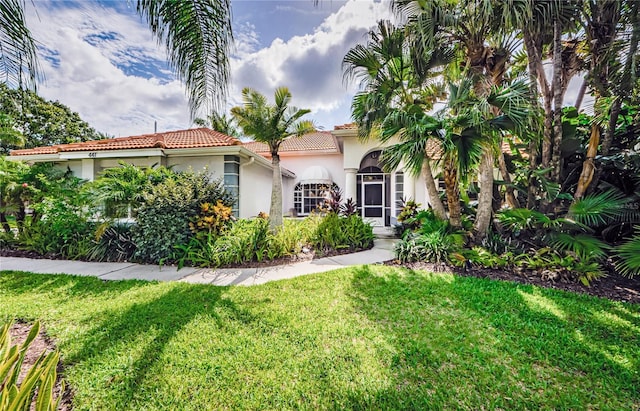 mediterranean / spanish-style house with a front yard