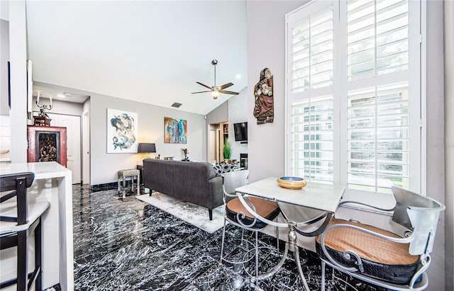 living room featuring high vaulted ceiling and ceiling fan