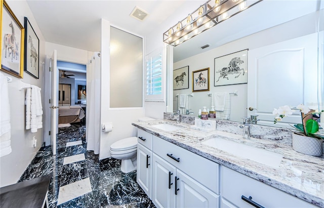 bathroom featuring vanity, toilet, and ceiling fan