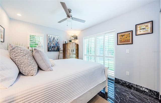 bedroom featuring multiple windows and ceiling fan