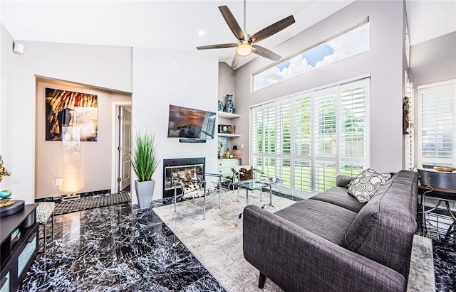 living room featuring high vaulted ceiling and ceiling fan