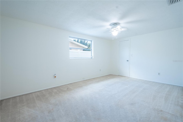 carpeted empty room featuring ceiling fan