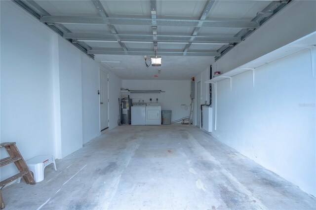 garage with washer and dryer, a garage door opener, and water heater