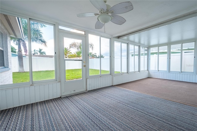 unfurnished sunroom featuring a wealth of natural light and ceiling fan