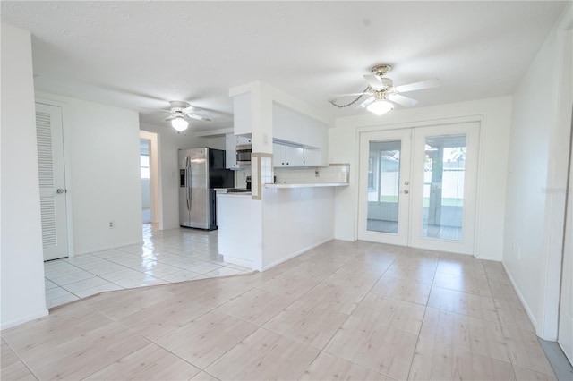 kitchen with ceiling fan, french doors, stainless steel appliances, kitchen peninsula, and white cabinets