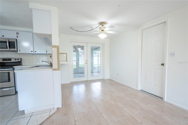 kitchen with french doors, sink, ceiling fan, tasteful backsplash, and stainless steel appliances