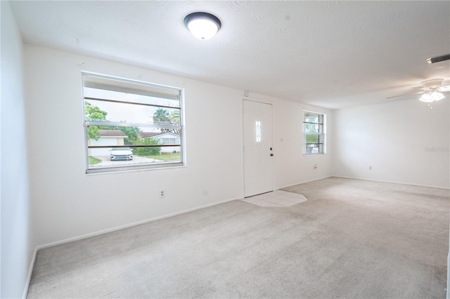 unfurnished room with light carpet and ceiling fan