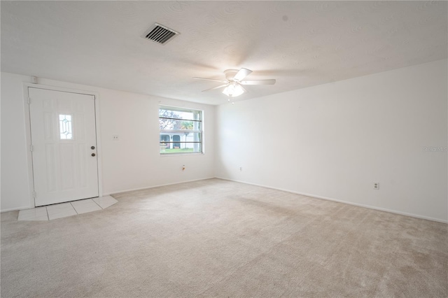 interior space featuring ceiling fan and light colored carpet