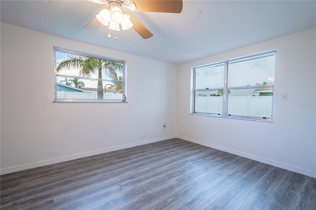 spare room with ceiling fan and dark wood-type flooring