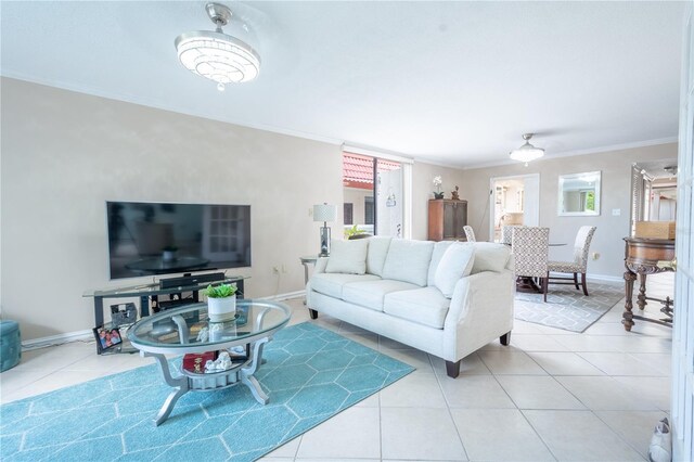 living area featuring light tile patterned floors, baseboards, and ornamental molding