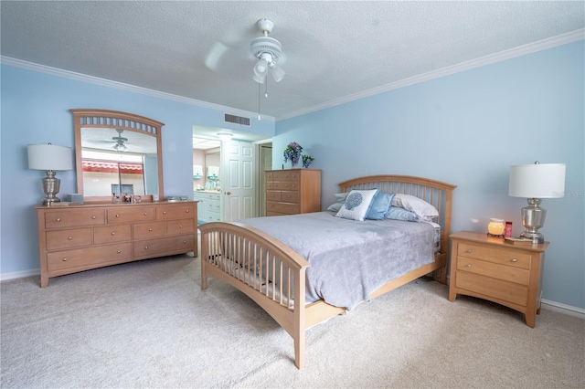 bedroom featuring crown molding, a textured ceiling, visible vents, and light colored carpet