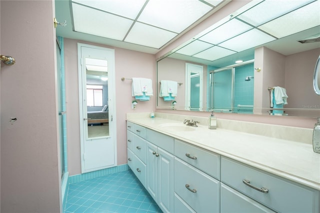 bathroom with a shower stall, tile patterned flooring, and vanity