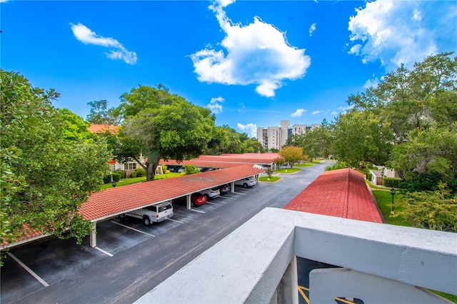 view of community with covered and uncovered parking