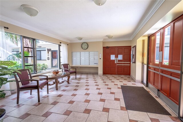 entrance foyer featuring ornamental molding, baseboards, and mail area