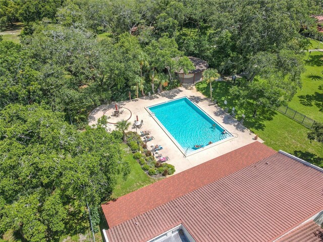 community pool featuring a patio, a yard, and fence