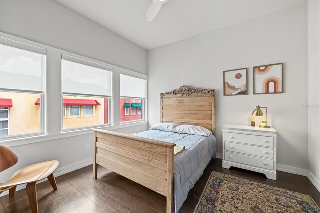 bedroom with dark hardwood / wood-style flooring and ceiling fan