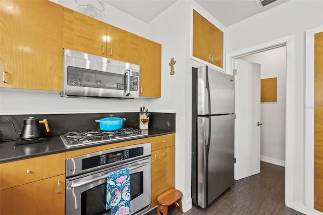 kitchen with dark wood-type flooring and stainless steel appliances