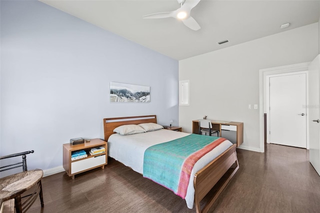 bedroom with dark hardwood / wood-style flooring and ceiling fan