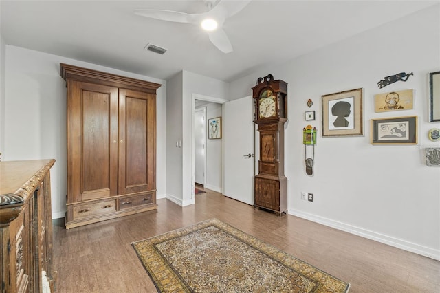 interior space featuring ceiling fan and dark hardwood / wood-style flooring