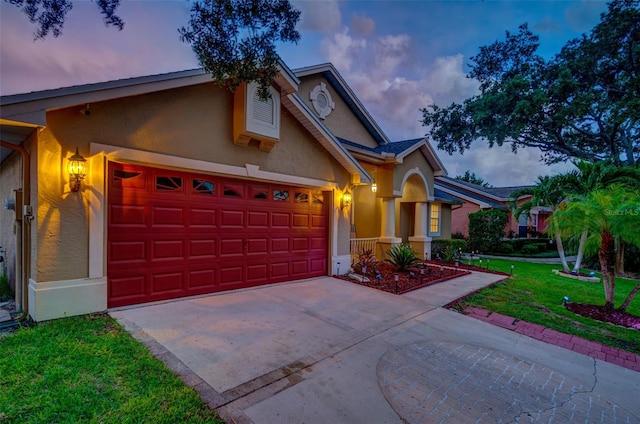 view of front of property with a yard and a garage