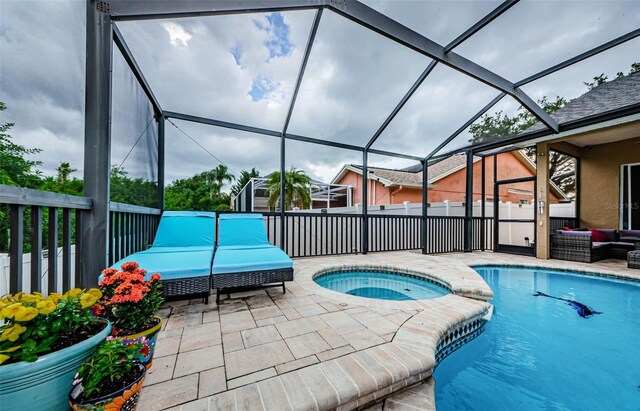 view of pool featuring a lanai, a patio, and an in ground hot tub