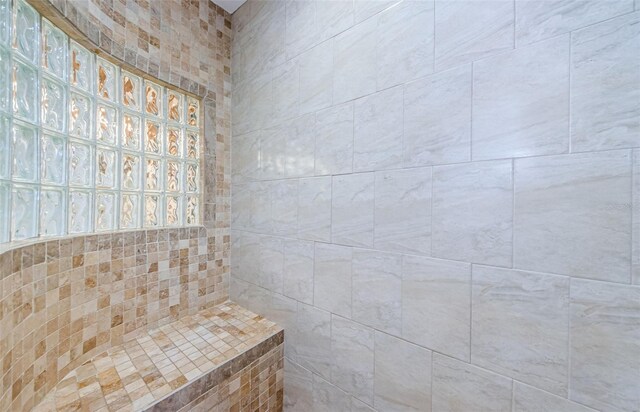 bathroom with tiled shower