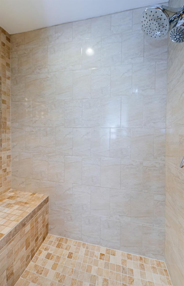 bathroom with a tile shower