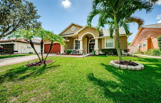 ranch-style home with a garage and a front lawn