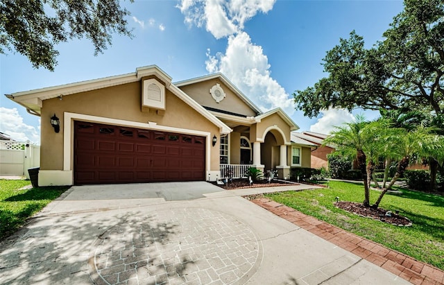 ranch-style house with a front yard, covered porch, and a garage