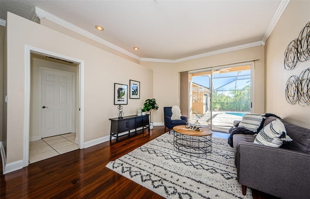 living room with hardwood / wood-style flooring and crown molding