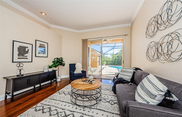 living room with ceiling fan, dark hardwood / wood-style flooring, and ornamental molding