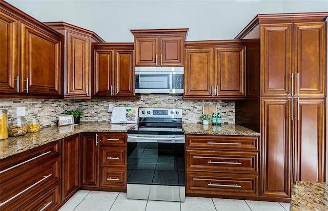 kitchen featuring tasteful backsplash, light tile patterned floors, appliances with stainless steel finishes, and light stone counters