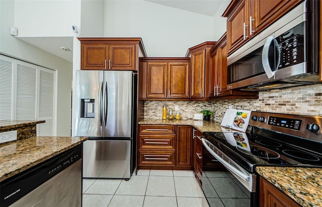 kitchen featuring stainless steel appliances, backsplash, light tile patterned flooring, high vaulted ceiling, and light stone countertops