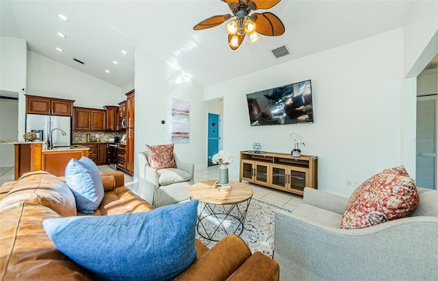 living room with high vaulted ceiling, light tile patterned floors, ceiling fan, and sink