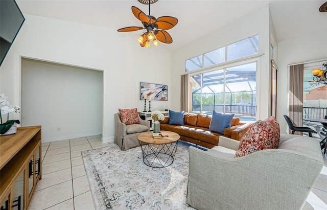 957 Westwinds Blvd, Tarpon Springs, FL 34689 - living room featuring ceiling fan, light tile patterned floors, baseboards, and a high ceiling