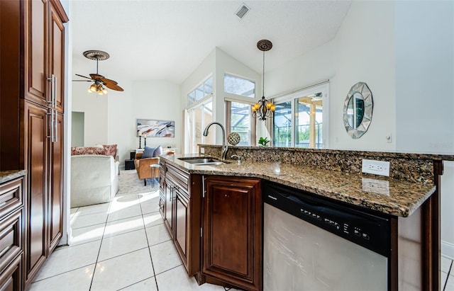 957 Westwinds Blvd, Tarpon Springs, FL 34689 - kitchen featuring stainless steel dishwasher, a sink, pendant lighting, lofted ceiling, and dark stone counters
