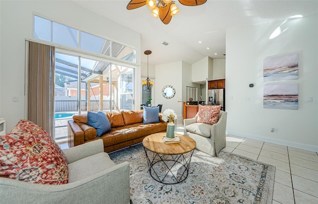 tiled living room with ceiling fan, vaulted ceiling, and sink