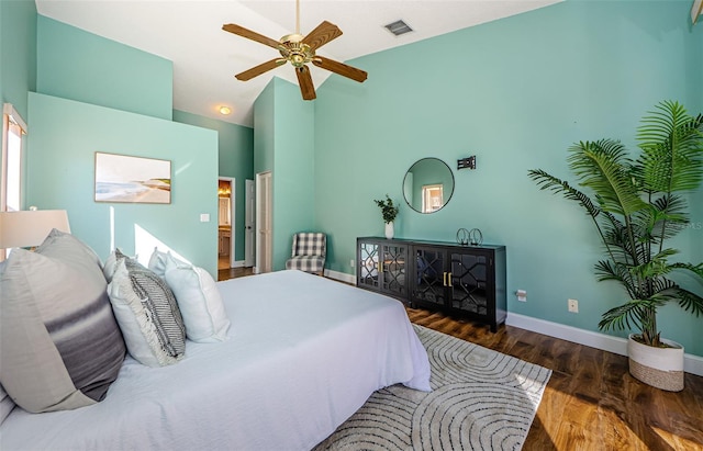 bedroom with ceiling fan, dark hardwood / wood-style flooring, and lofted ceiling