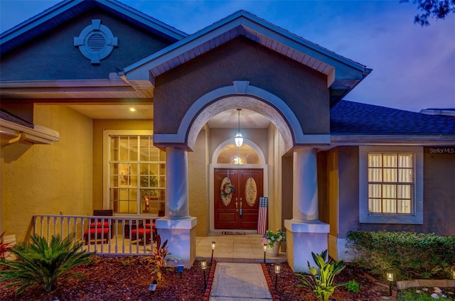 exterior entry at dusk with covered porch