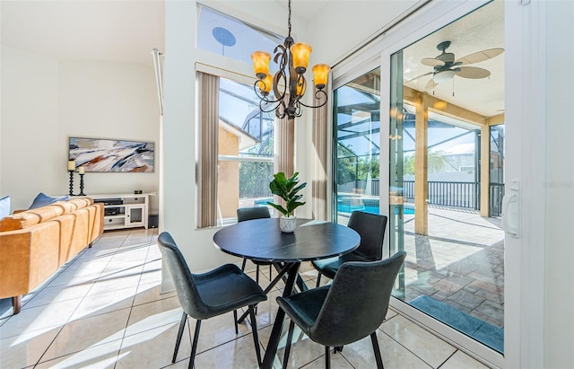 tiled dining area featuring ceiling fan with notable chandelier