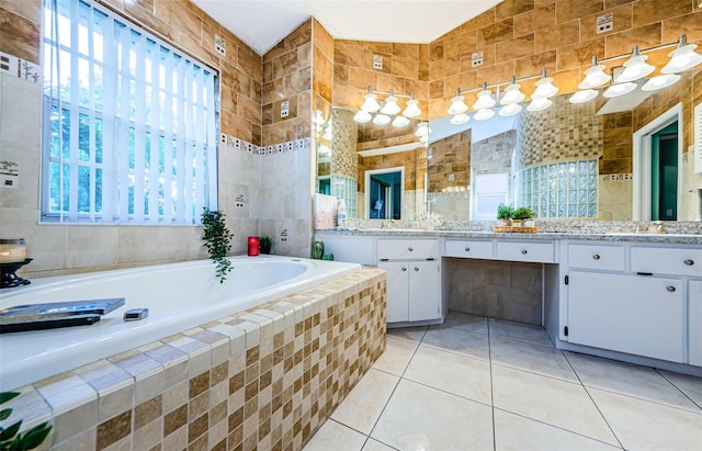 bathroom with lofted ceiling, tile patterned flooring, tile walls, and vanity