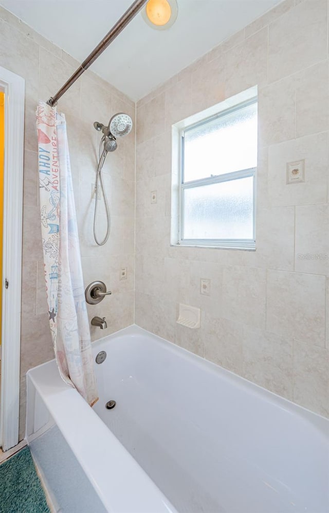 bathroom featuring shower / bathtub combination with curtain