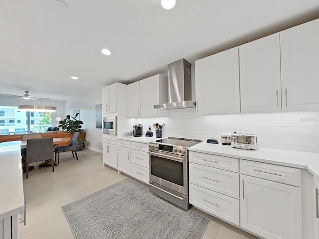 kitchen with white cabinetry, wall chimney exhaust hood, and stainless steel appliances