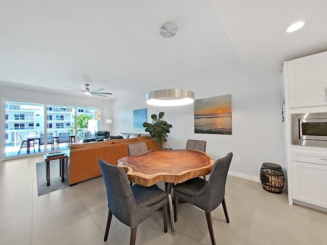 tiled dining space with ceiling fan