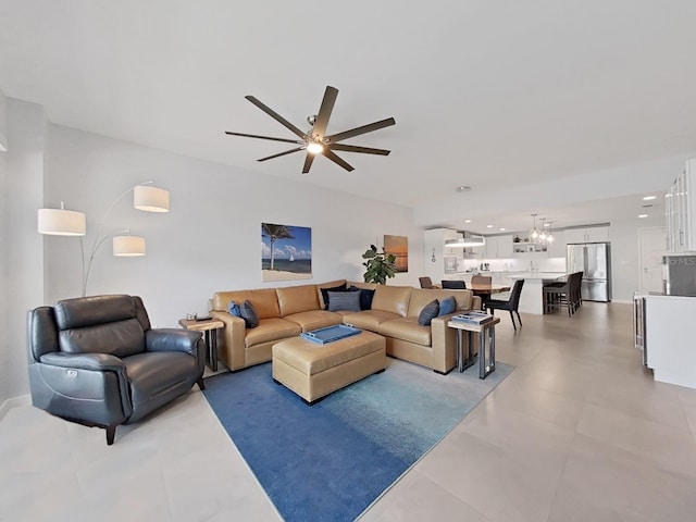 living room featuring ceiling fan with notable chandelier