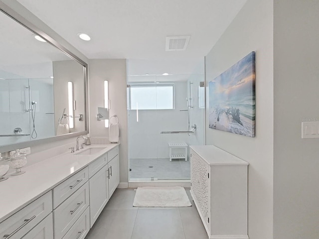 bathroom with vanity, tile patterned flooring, and walk in shower