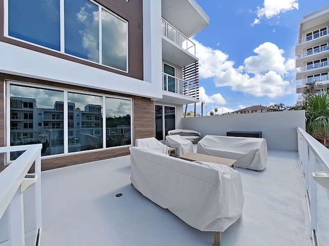 view of patio featuring a balcony