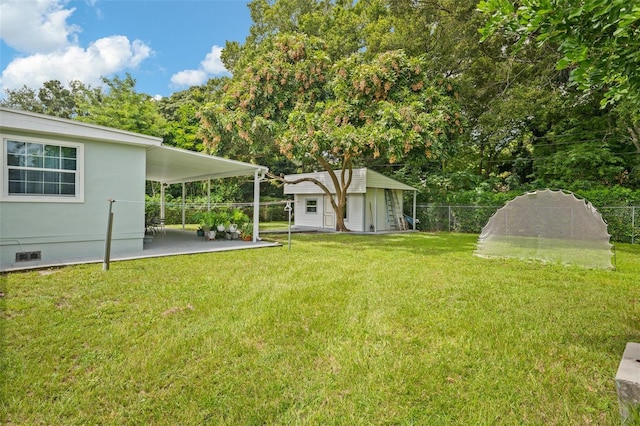 view of yard with an outbuilding and a patio area